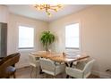 Dining room with wooden table, modern chairs, and a chandelier at 3701 S Grant St, Englewood, CO 80113