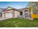 Charming home exterior with a well-kept lawn, an American flag, and a welcoming front porch at 13397 Franklin St, Thornton, CO 80241