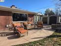 A pleasant outdoor patio with wicker furniture and a view of the backyard storage shed at 1004 W Shepperd Ave, Littleton, CO 80120