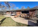 Comfortable outdoor seating on a brick home's patio with a swing and sunny skies at 1004 W Shepperd Ave, Littleton, CO 80120