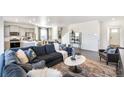 A well-designed living room featuring hardwood floors, a comfortable sofa, and bright lighting at 1813 Pinnacle Ave, Lochbuie, CO 80603