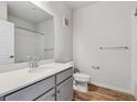 Bathroom featuring a single sink vanity, toilet, and shower with wood-style floor at 485 Interlocken Blvd # 202, Broomfield, CO 80021