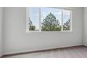 Bright bedroom with gray carpet and a large window providing scenic views at 485 Interlocken Blvd # 202, Broomfield, CO 80021