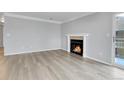 Bright living room featuring a cozy fireplace and wood flooring, perfect for relaxing evenings at 3093 S Ursula Cir # 302, Aurora, CO 80014