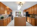 Bright kitchen with an island, stainless steel appliances, granite countertops, and a cozy breakfast nook at 1539 S Quail St, Denver, CO 80232