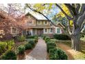 Two-story home with a walkway leading to the front door and lush landscaping at 5110 S Logan Dr, Greenwood Village, CO 80121
