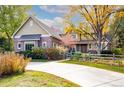 Two-story home with brick and siding, a landscaped yard, and a wooden fence at 5110 S Logan Dr, Greenwood Village, CO 80121