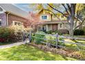 House exterior showcasing a brick and light-brown sided home with a split-rail fence at 5110 S Logan Dr, Greenwood Village, CO 80121