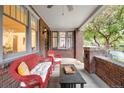 Charming front porch with comfortable wicker seating, brick accents, and outdoor charm at 730 Cook St, Denver, CO 80206