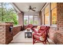 Inviting front porch with cozy seating, brick columns, and ceiling fan at 730 Cook St, Denver, CO 80206
