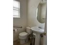 Bathroom features a sink, toilet, and window at 18336 E Amherst Dr, Aurora, CO 80013