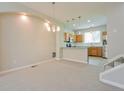 Open-concept design shows modern kitchen with pendant lights adjacent to living and dining area at 9300 E Florida Ave # 1506, Denver, CO 80247