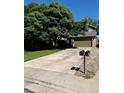 Well-kept lawn and a spacious driveway to a two-car garage at 5201 E 127Th Dr, Thornton, CO 80241