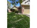 Charming home featuring a well-manicured lawn and an inviting entryway at 5201 E 127Th Dr, Thornton, CO 80241
