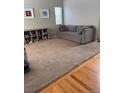Comfortable living room featuring neutral walls, plush carpeting, and a cozy couch at 5201 E 127Th Dr, Thornton, CO 80241