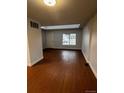 Spacious living room featuring beautiful wood floors and a large window for natural light at 6396 S Hill St, Littleton, CO 80120