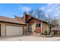 Charming home featuring a covered front porch, two car garage, and low-maintenance landscaping at 673 Brentwood St, Lakewood, CO 80214