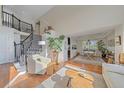 Inviting living area with hardwood floors, staircase, and open layout to the dining area, perfect for entertaining at 10127 W 100Th Ct, Westminster, CO 80021