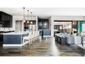 Open-concept living space with a gourmet kitchen, bar area, and sliding doors to the outdoor living space at 9388 E 59Th Pl, Denver, CO 80238