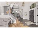 Bright open foyer showcases wood and tile flooring, staircase with railing, and soaring ceilings at 1588 W 111Th Ave, Northglenn, CO 80234