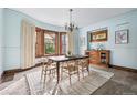 Bright dining room with bay window and wood-trimmed walls at 1149 Steele St, Denver, CO 80206