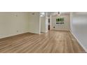 Inviting living area with wood-look floors and a window providing natural light at 5380 S Prescott St, Littleton, CO 80120