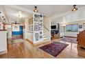 Hallway with wood floors, decor, stairs and an open archway into the living room at 1069 Crestmoor Dr, Boulder, CO 80303