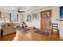 Cozy living room with hardwood floors, shutters, and a stained glass front door at 1069 Crestmoor Dr, Boulder, CO 80303