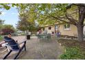 A flagstone patio is furnished with a table, chairs, and landscaping at 1069 Crestmoor Dr, Boulder, CO 80303