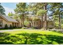 Attractive home exterior with lush green lawn and mature trees at 2521 Juniper Ct, Golden, CO 80401