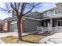 Beautiful gray home featuring an attached garage and picket fence at 12613 Knox Pt, Broomfield, CO 80020