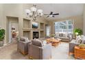 Cozy living room features a fireplace, neutral tones, and natural light at 12613 Knox Pt, Broomfield, CO 80020