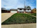 Inviting two-story home with light siding, brick details, and a spacious two car garage at 465 Salem St, Aurora, CO 80011