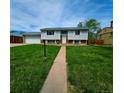 Traditional two-story home with light siding and a well-maintained lawn at 465 Salem St, Aurora, CO 80011