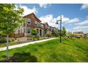 Street view of homes in a neighborhood with manicured lawns and landscaping at 1125 Anker Dr, Erie, CO 80516