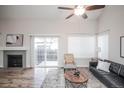 Cozy living room with fireplace, sliding door to backyard, and vaulted ceiling at 2217 S Nome Ct, Aurora, CO 80014