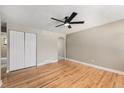 Spacious bedroom featuring hardwood floors, a ceiling fan and a closet at 1150 Rosemary St, Denver, CO 80220