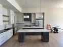 Modern kitchen with two islands, custom cabinets, and stainless steel appliances at 5841 Powell Rd, Parker, CO 80134