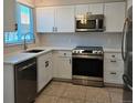 Bright kitchen with stainless steel appliances and white cabinetry at 886 Summer Dr, Highlands Ranch, CO 80126