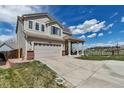 Beautiful two-story home with a covered front porch, attached garage, and well-kept lawn at 19593 E Hollow Creek Dr, Parker, CO 80134