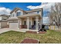 Well-maintained home featuring a cozy front porch and a neatly landscaped front yard at 19593 E Hollow Creek Dr, Parker, CO 80134