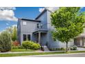 Charming two-story home featuring modern architecture, a well-manicured lawn, and lush landscaping at 6760 Mariposa Ct, Denver, CO 80221