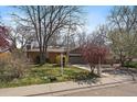 Single-story home with a brick exterior, two-car garage and a manicured front lawn at 1746 Shavano St, Longmont, CO 80504