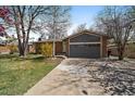 A close view of the house showing the two-car garage, and manicured front lawn at 1746 Shavano St, Longmont, CO 80504