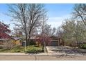 A front elevation of single-story home with a two-car garage and mature shade trees at 1746 Shavano St, Longmont, CO 80504
