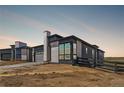 Modern home with stone accents, large windows, and a well-maintained landscape in a desirable neighborhood at 6845 Fawn Path Way, Castle Pines, CO 80108