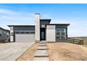 Beautiful new construction home boasts a modern design with stone accents and a welcoming entrance at 6845 Fawn Path Way, Castle Pines, CO 80108
