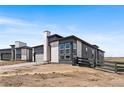 Modern home with stone accents, large windows, and a well-maintained landscape in a desirable neighborhood at 6845 Fawn Path Way, Castle Pines, CO 80108