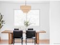 Modern dining room with stylish light fixture and seating for four at 6211 W Fremont Pl, Littleton, CO 80128