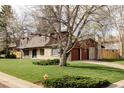 Charming home with a two-car garage, mature landscaping, and inviting curb appeal at 6211 W Fremont Pl, Littleton, CO 80128